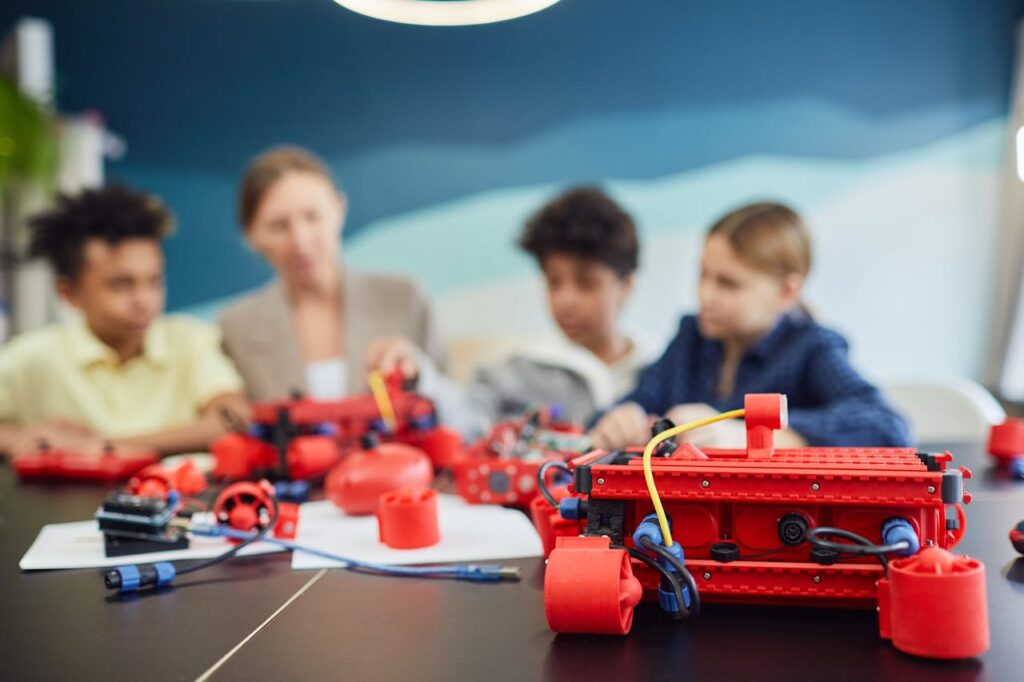 Group of kids working on robotics project, engaging in STEM education.
