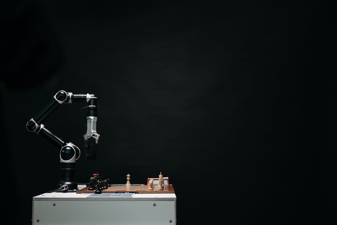 An articulated robotic arm competes in chess on a board against a dark background, highlighting AI and innovation.